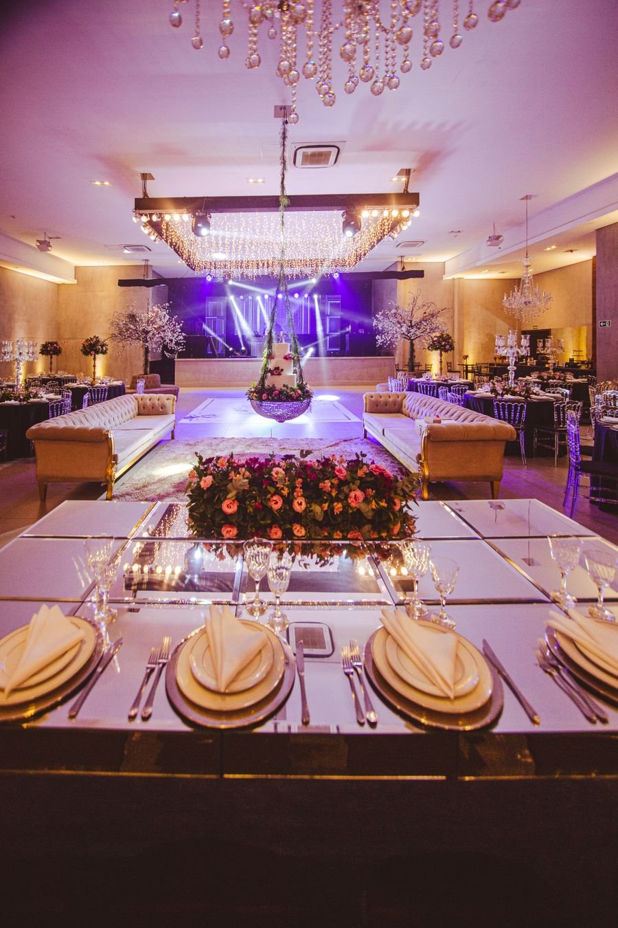 Gala dinner setup with mirrored head table and lounge seating